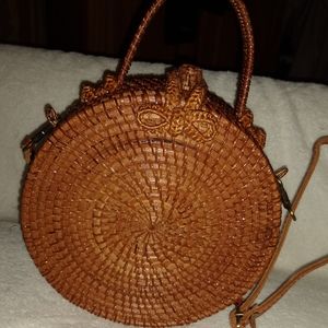 Round rattan crossbody bag.